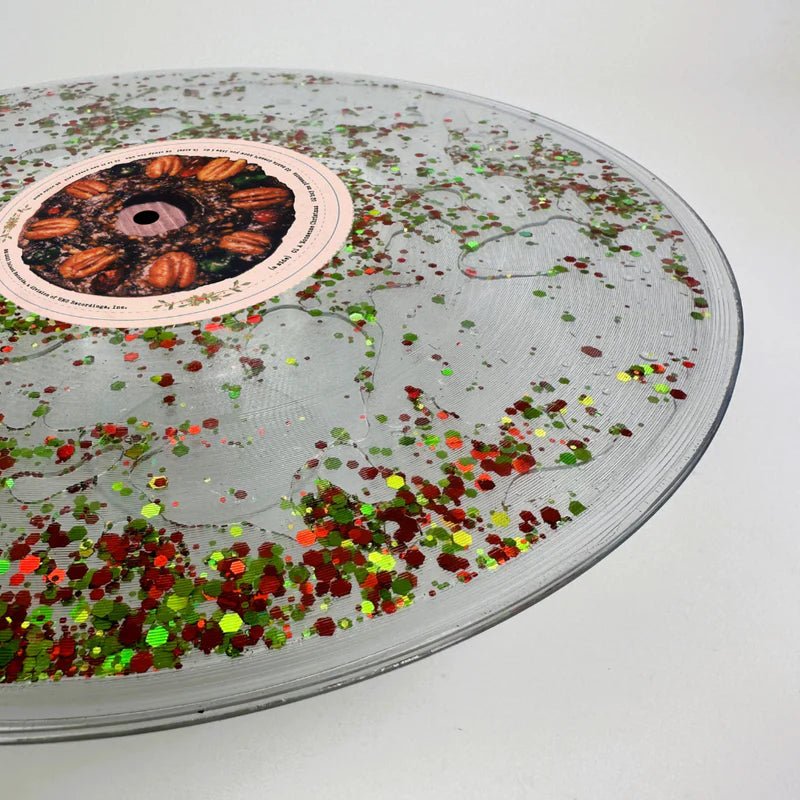 Sabrina Carpenter - Vinilo Fruitcake disco líquido lleno de purpurina verde y roja
